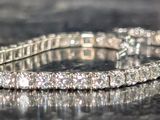 a close up of a diamond bracelet on a table