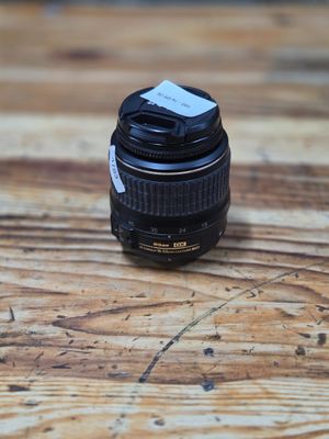 a camera lens sitting on top of a wooden table
