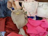 a pile of clothes that is sitting on the floor