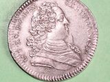 a close up of a coin on a green surface
