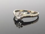 an image of a diamond ring on a reflective surface