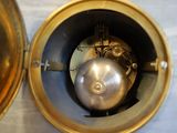 a gold clock with a silver ball in the middle of it