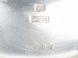 a close up of a silver plate with a number on it