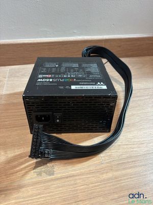 a computer power supply unit sitting on top of a wooden table