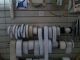 many rolls of paper on a rack in a store
