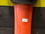 a small blower attached to a yellow and black striped wall