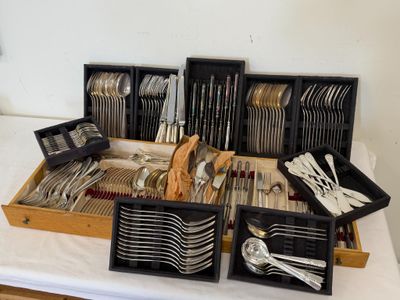 a lot of silverware in the trays on the table