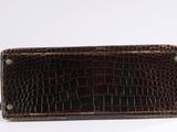brown alligator skin wallet on a white background