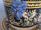 a cup and saucer with a blue lion head on it