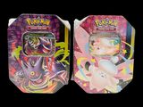 two tins of pokemon cards are shown on a black background