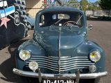 an old car that is parked in a parking lot