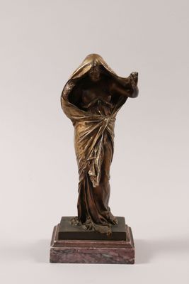 a bronze statue of a woman with a veil on her head