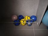 a bunch of balls that are on the floor next to a gym ball