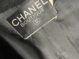 a close up of a chanel label on a black jacket