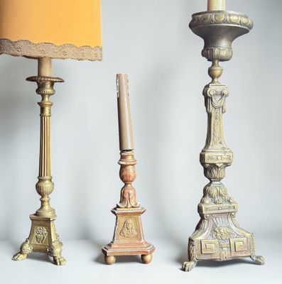 three candles that are sitting next to each other on a table