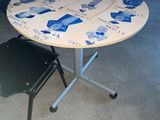 a table with a chair and a stool in a room