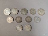 six different types of coins are arranged on a table