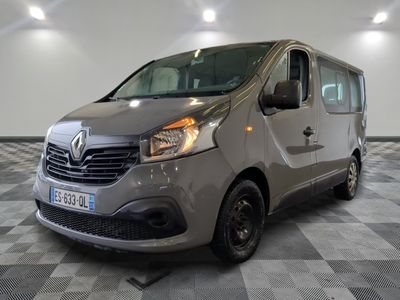 the grey van is parked on a checkered floor in the garage