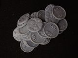 a pile of white buttons on a black surface
