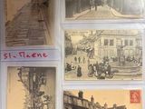 many old postcards on display on a table