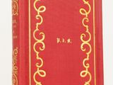 an old red book with a gold border on it