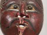 an image of a wooden mask on a stand