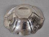 a silver plate on a table with a tag on it
