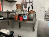 a kitchen with a lot of utensils on the shelves