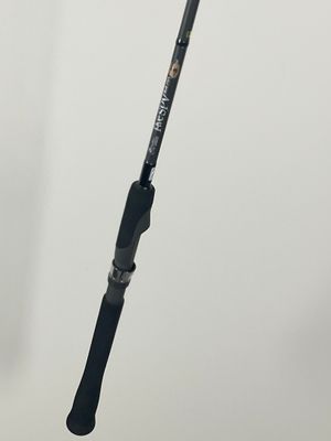 a close up of a fishing rod on a white surface