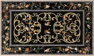 a black area rug with a floral design on it