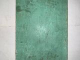 a green book sitting on a white wall