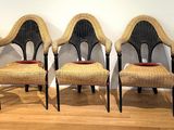 four chairs are lined up in a row on a wooden floor
