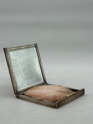 an old silver box with a mirror on top of it