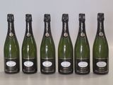 six bottles of champagne lined up in a row on a table