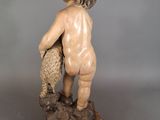 statue of a child with a fish in his hand
