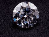 a close up of a diamond on a black surface