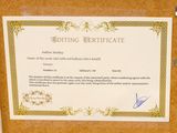 a certificate on a cork board with a picture of a man
