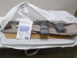 a white bag with some items in it sitting on a table