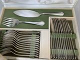 many forks and spoons in a box on the table