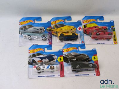 five hot wheels cars that are on display on the table