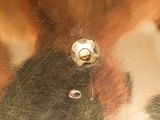 a close up of a metal object with a metal button on it