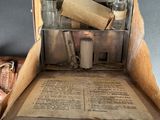 an open box with a book and some bottles in it