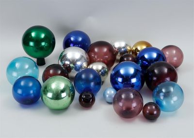 a lot of different colored glass balls on the table