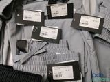 a suit case full of clothes with tags on it