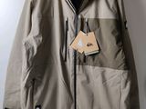 the jacket is hanging on a hanger on the wall
