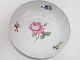 a white plate with a pink rose painted on it