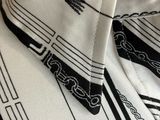 an image of a black and white scarf with a design on it