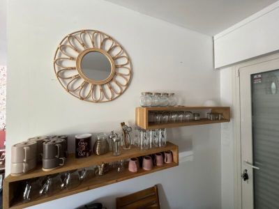 many cups and glasses on the shelves in the room
