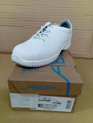 the white shoe is sitting on top of a box on the floor
