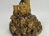 a small statue of a castle on top of a rock
